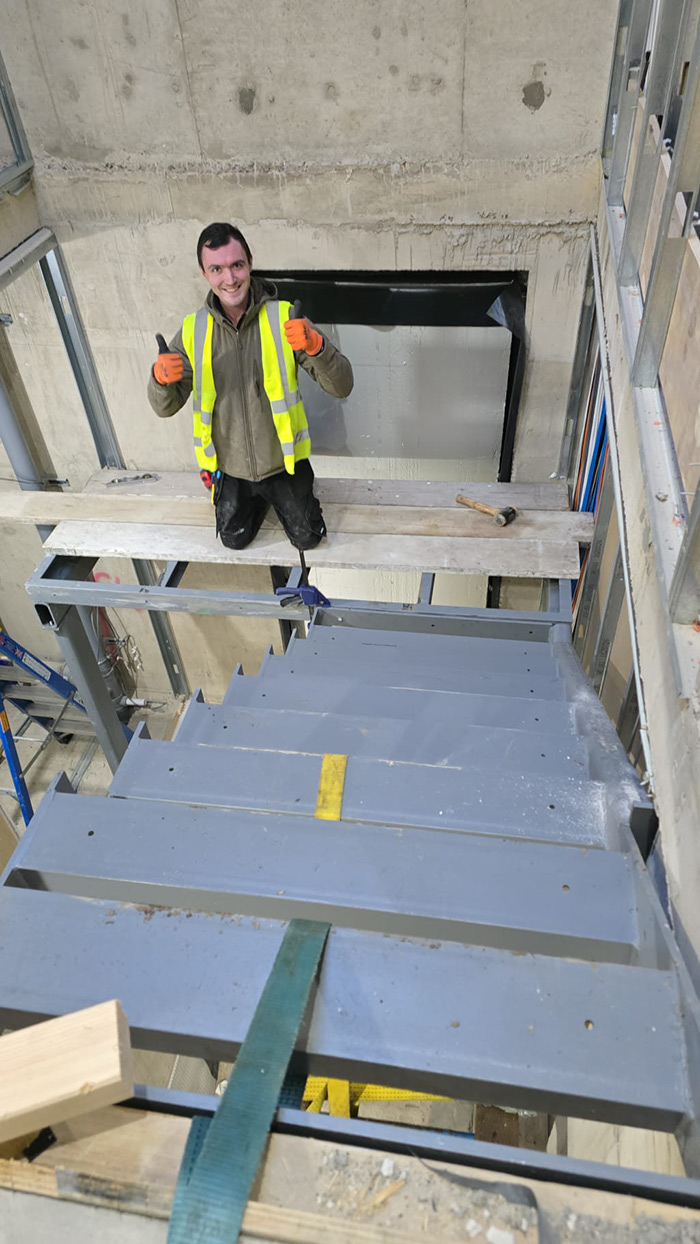 staircase with a metal frame and wooden treads