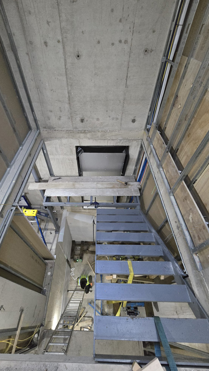 staircase with a metal frame and wooden treads